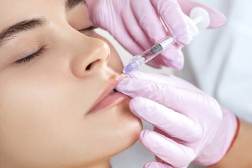 A young attractive woman getting dermal filler in her lips
